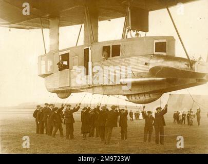 The forward gondola of the R34. The airship is being eased up, preparatory to flight, when the lines held by the groundcrew will be released from the handling rail. 14 March 1919 (the first flight). Stock Photo