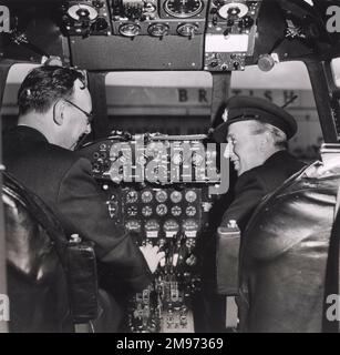Peter Masefield, chief executive, BEA, and team manager of the BEA crew (left), going through cockpit drill with Capt W. Baillie, chief flight captain of BEA and pilot in command of the Viscount Endeavour, G-AMAV, in the New Zealand Air Race. Stock Photo