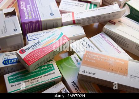 Close-up of a table with many boxes of medicines of all kinds such as ibuprofen, antibiotics, nolotil, etc. Stock Photo