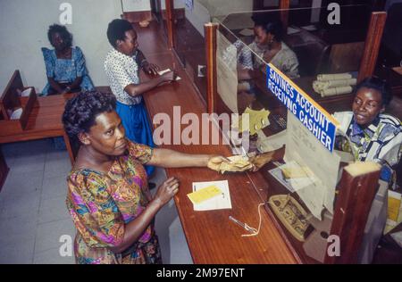 Uganda, Kampala; woman collects money at a bank. Stock Photo