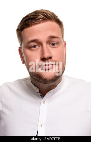 Close up horizontal portrait of a handsome man with a beard, stylish haircut, wearing a white shirt, isolated on a white background Stock Photo