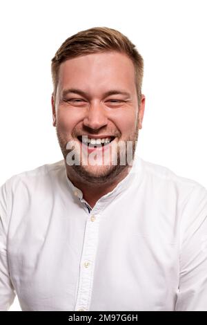 Close up horizontal portrait of a handsome man with a beard, stylish haircut, wearing a white shirt, isolated on a white background Stock Photo