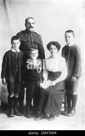 WW1 family portrait with father in the army and one young son wearing naval uniform Stock Photo