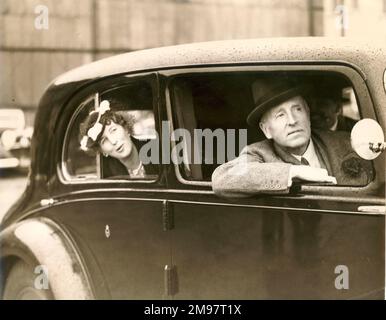 Lord and Lady Londonderry watch the flying from their car as they shelter from the rain at the 1939 Royal Aeronautical Society Garden Party at the Fairey Aviation Aerodrome, Great West Road, Hayes, Middlesex. Lord Londonderry was a former Secretary of State for Air. Stock Photo