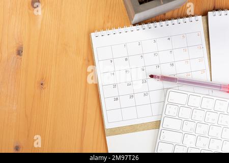 Calendar and agenda reminders, work from home online. desktop calendar with  stationery and pen pencil, keyboard. mark a holiday trip or plans in a dia  Stock Photo - Alamy