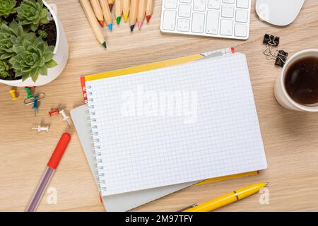 Back to school concept. Top view photo of notepads, pens, sharpeners, ruler, staplers, clips, markers and erasers on wooden table Stock Photo