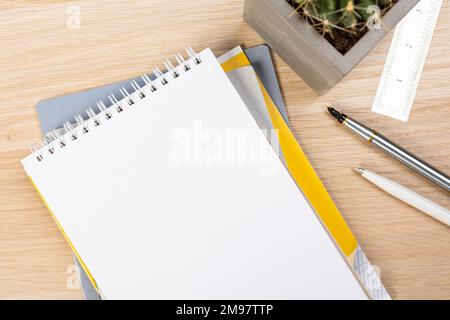 Back to school concept. Top view photo of notepads, pens, sharpeners, ruler, staplers, clips, markers and erasers on wooden table Stock Photo