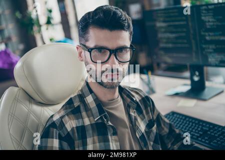 Photo of serious concentrated cybersecurity expert man sitting leather chair operating database open space indoors Stock Photo