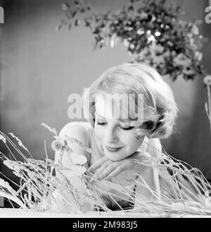 Advertisement for Nivea shampoo -- female model (Sandra Paul) posing in the grass. Stock Photo