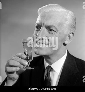 Advertisement for Emu sherry -- smiling male model (George McGrath) holding up a glass. Stock Photo