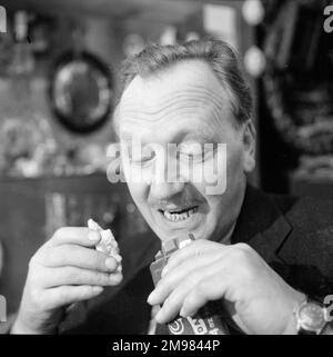 Advertisement for Cadbury's chocolate -- male model (Jack Todd) posing in an antique shop. Stock Photo