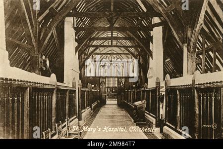 Saint Marys Hospital Chapel - Chichester, W H Barrett Postcard. St Marys is a remarkable survival of a 13th Century hospital.  It has kept its ancient buildings and endowments, and is still in use today as an almshouse providing sheltered accommodation for the elderly. The interior is notable for its timber and beam construction. Stock Photo