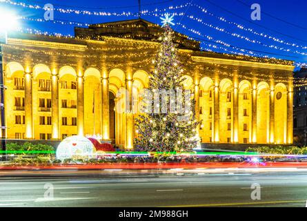 Illuminated Christmas tree in front of Parliament building on Rustaveli Avenue at night, Tbilisi, Georgia Stock Photo