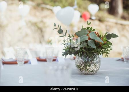 Bunch of flowers on a formal table setting in a garden, Spain Stock Photo