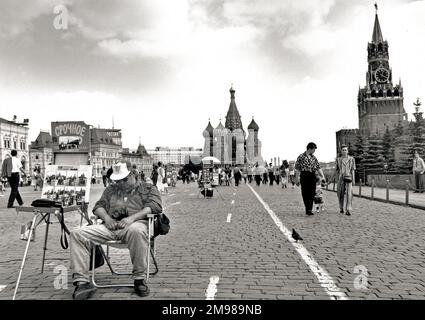 Scene in Red Square, Moscow, Russia, with a photographer asleep in a chair. Stock Photo