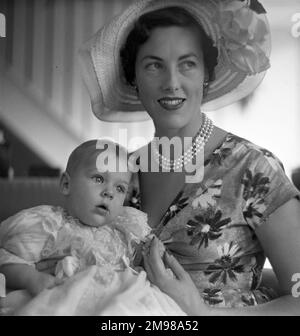 Mother and child after a christening, formal portrait. Stock Photo