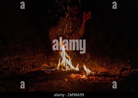 ZAGROS, IRAN - JULY 7, 2019: Nomad at a camp fire in Zagros mountains, Iran Stock Photo