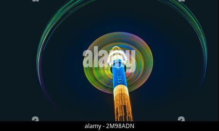 Colorful abstract traces of high whirling carousel on black background Stock Photo