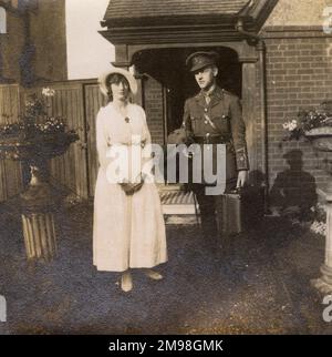 Soldier on leave, about to return to duty, standing with his fiancee in front of her home in Cheam, Surrey, during the First World War. They are Albert Auerbach and Molly Bowie. She is wearing his Royal Fusiliers badge on her blouse. Stock Photo