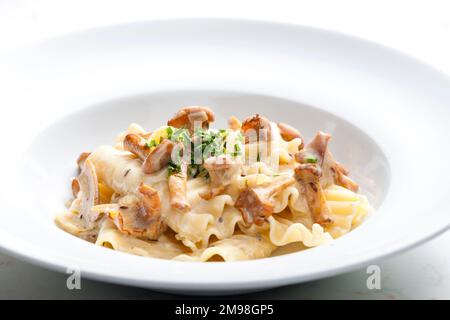 cream sauce with chanterelles served with pasta Stock Photo