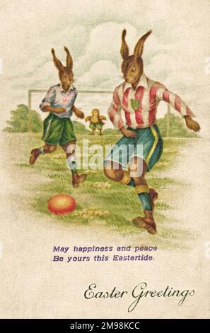 Rabbits playing football on an Easter postcard, with a chick as goalkeeper. Stock Photo