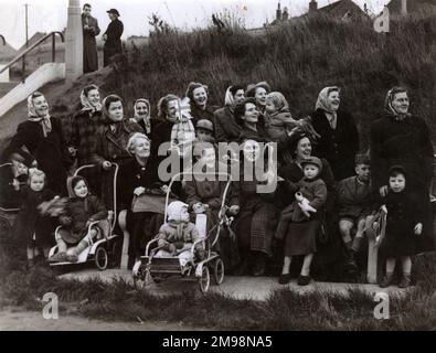 A group of expectant ladies (Mother, Grandmothers and their young children) awaiting the arrival of the Duke of Edinburgh during his visit to Edlington, South Yorkshire. Stock Photo