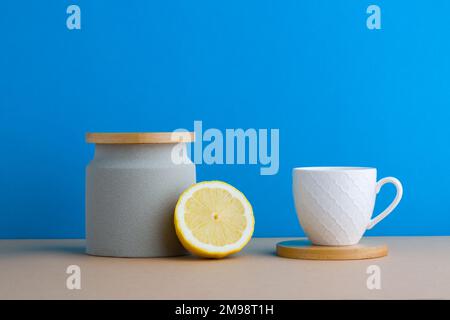 A front view of lemon decorated with tea in blue background Stock Photo