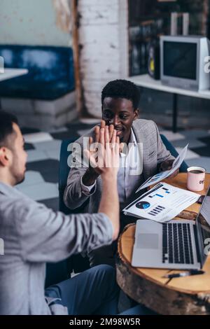Business colleagues giving high five in office. Stock Photo