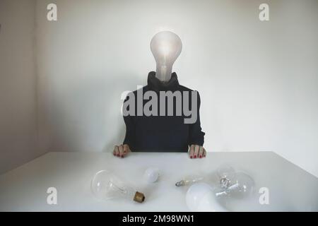 surreal person with a light bulb placed on his head who chose the best idea, concept of choice, creativity, business, ideas, freedom Stock Photo