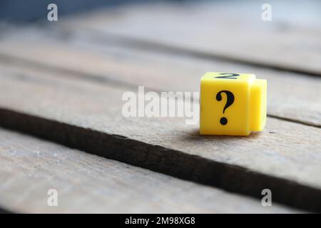 Question mark on a yellow cube. Place for text. Vintage style. Stock Photo