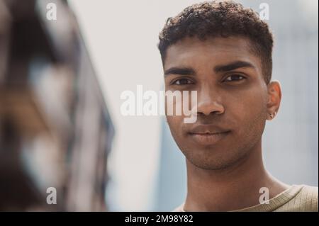 Handsome young man with a double lobe piercing standing outdoors Stock Photo