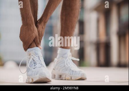 Professional sportsman suffering from a lower leg injury Stock Photo