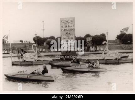 Boating Lake - British Seaside Scene, Southend-on-Sea, Essex - The sign is advertising Peter Pan's Playground - 'the ideal place to take the children'. Stock Photo