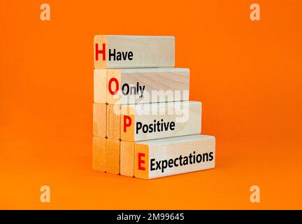 HOPE have only positive expectations symbol. Concept words HOPE have only positive expectations on block on beautiful orange background. Business HOPE Stock Photo