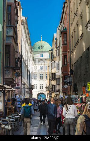 Innsbruck tourism, view in summer of people browsing at tourist souvenir stalls in the Hofgasse in the center of Innsbruck old town - the Altstadt. Stock Photo
