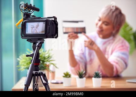 Female Vlogger Recording Beauty And Make Up Video At Home With Camera Stock Photo