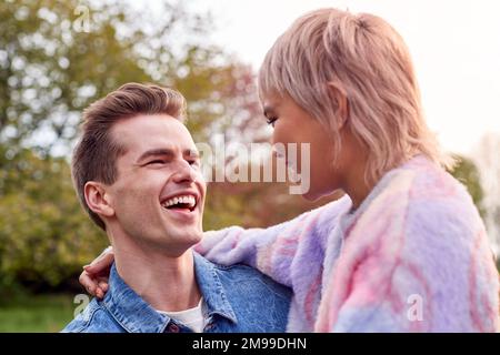 Loving Couple Outdoors In Countryside Laughing And Hugging Stock Photo