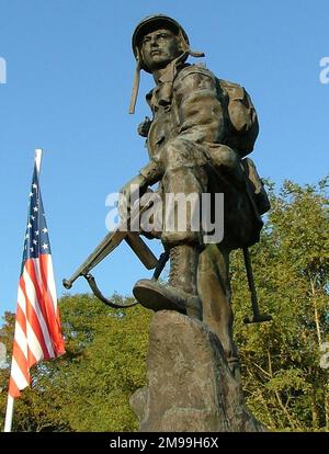 The bronze statue is a replica of one in the US Army  Infantry School at Fort Benning. This one was unveiled by Major General Kellog Commander 82nd Airborne on 7 June 1997. A number of memorial plaques attend the figure. Stock Photo