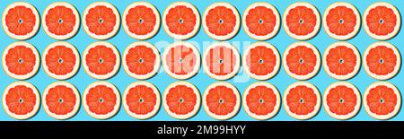 Grapefruit rings on a blue background. Bright juicy background. Concept. Stock Photo