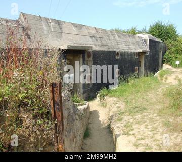 The bunker is on Routes des Perruques, Grandcamp-Maisy. The area is thought to have held 155mm guns and 10.5cm howitzers and was taken by the 5th Rangers after a 5 hour battle on 9 June 1944. Stock Photo