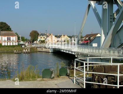 This view is from the east bank of the Orne Canal, (the side where the gliders landed). The Gondree Caf‚ is on the left and the German gun pit and the bridge are on the right. The first glider landings were made here under the Command of former Oxford policeman Major John Howard. There are several memorials in the area including a bust of Major Howard. Stock Photo