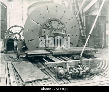 Photograph of "Old Face Plate Lathe", originally installed in the Soho Foundry of Boulton and Watt, Birmingham which was purchased by Avery in 1895. The lathe taking work up to 26 feet diameter. In the foreground is shown the universal joint, 3-speed gear and differential. This lathe was brought to the Soho Foundry as old equipment in 1796. The driving gear, hidden by the big plate, has wooden teeth which are still in perfect working order [when photographed]. Stock Photo