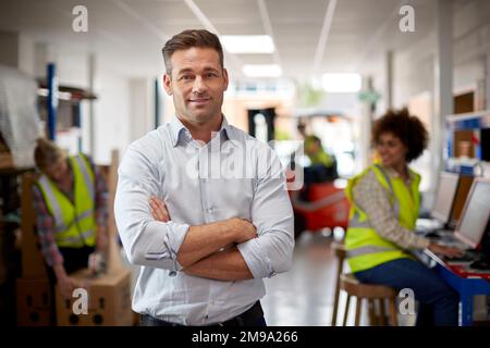 Portrait Of Male Manager In Logistics Distribution Warehouse Stock Photo
