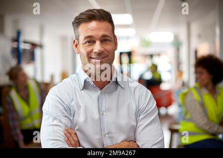 Portrait Of Male Manager In Logistics Distribution Warehouse Stock Photo