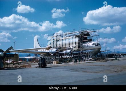 Pregnant Guppy N1024V under construction with On Mark Engineering at LAX - March 1962. The conversion was carried out in stages, First a portion of BOAC Stratocruiser was inserted in the rear fuselage and then the large outer shell of the cargo compartment was added to the standard B337 fuselage, for aerodynamic and structural trials. After the aircraft flew successfully and was demonstrated to Wernher von Braun, sufficient interest was generated to complete the conversion by cutting away the standard fuselage inside the large shell. - (photographer - AR Krieger) Stock Photo