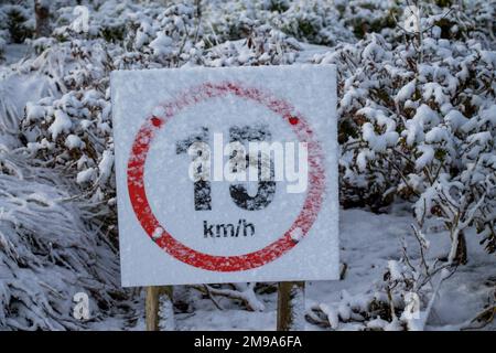 Speed Limit Sign Covered in Winter Snow Stock Photo