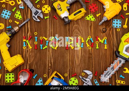 Colorful toy tools as frame with text Kids Room on wooden background Stock Photo