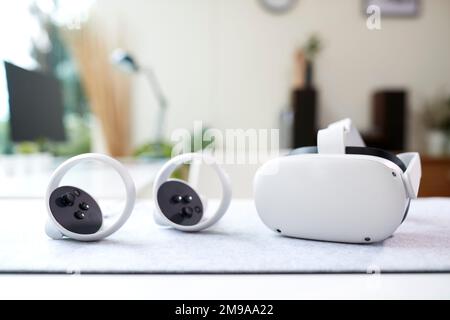 VR Headset And Gaming Controllers On Table At Home Stock Photo