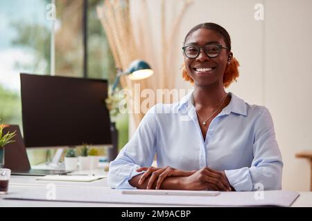 Portrait Of Smiling Businesswoman Working From Home Office Sitting At Desk Stock Photo