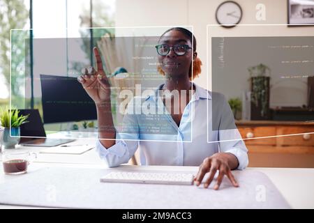 Woman Working From Home Office Looking At Projected Screen Interacting With AR Or VR Technology Stock Photo